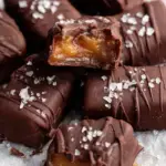 A close up of sliced 4 Ingredient Date Caramels on parchment paper