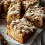A delicious slice of Apple Cider Coffee Cake with a golden cinnamon streusel topping.