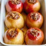 Whole Classic Baked Apples stuffed with oat crumble in a baking dish