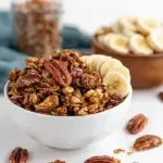 A tray of golden brown Banana Bread Granola with large clusters and chopped pecans