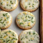 A tray of soft Best Mojito Sugar Cookies with a white lime glaze and fresh mint leaves