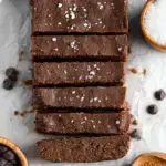 Dense and chewy chocolate Brownie Protein Bars sliced on parchment paper