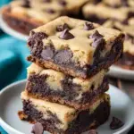 A stack of homemade Chocolate Chip Cookie Brownies showing the fudgy brownie layer and chewy cookie top