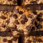 A stack of chewy Chocolate Chip Peanut Butter Oatmeal Bars on a wooden cooling rack