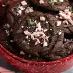 A plate of fudgy Gluten-Free Chocolate Peppermint Cookies with crushed candy canes on top