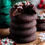 A tray of freshly baked Chocolate Thumbprint Cookies with smooth chocolate ganache centers on a wire rack.