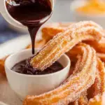Golden brown Classic Churros coated in cinnamon sugar on a platter