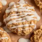 A stack of iced Cinnamon Roll Breakfast Cookies on a rustic plate