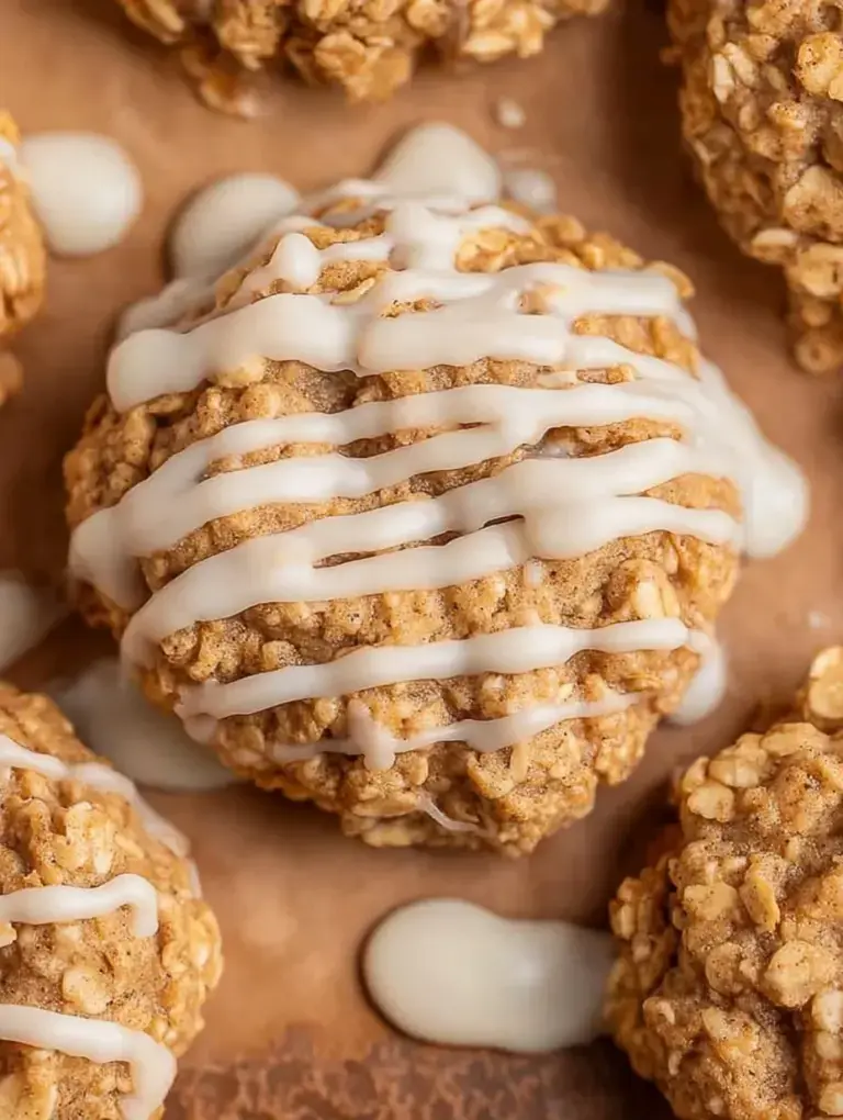 A stack of iced Cinnamon Roll Breakfast Cookies on a rustic plate