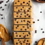 Homemade Vegan and Gluten-Free Cookie Dough Protein Bars sliced on parchment paper