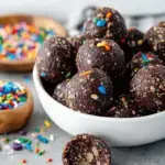 Healthy Gluten-Free Cosmic Brownie Bites with chocolate ganache and colorful candies