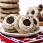 Chilled Crumbl Cookies & Cream Milkshake Cookies with frosting and mini cookie garnish