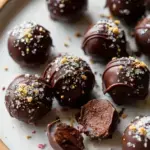 Handmade Dark Chocolate Peppermint Truffles coated in crushed candy canes and cocoa powder