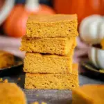 A stack of fudgy Easiest Vegan Pumpkin Brownies on a cooling rack