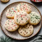 A tray of Easy Dairy-Free Christmas Sugar Cookies cut into holiday shapes like stars and trees