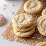 Golden brown Easy Sugar Cookies on a cooling rack in a cozy kitchen setting