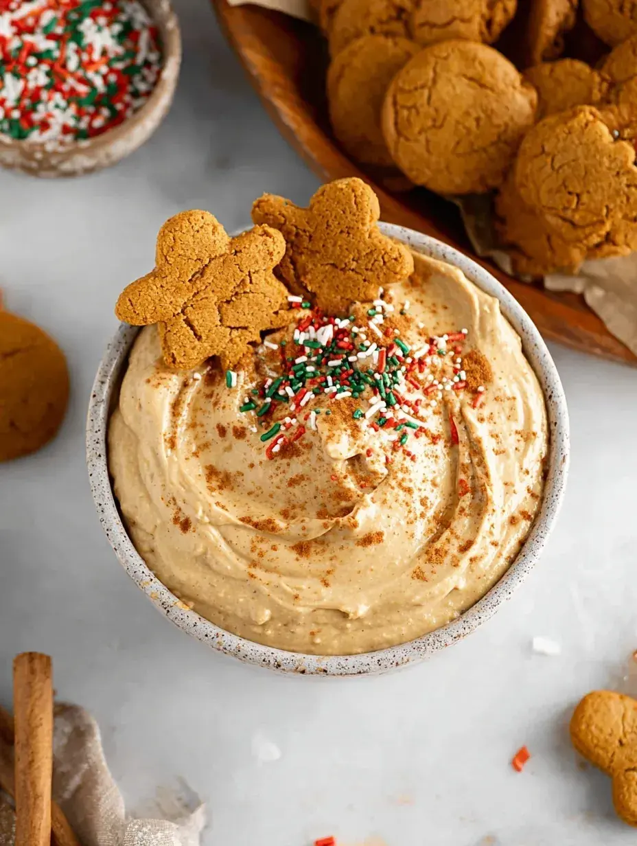 A bowl of creamy Gingerbread Cookie Dip surrounded by apple slices and gluten-free cookies