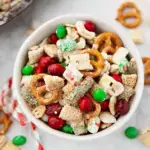 Large bowl of Gluten-Free Christmas Chex Mix with white chocolate and red and green M&Ms