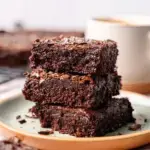 A stack of fudgy Healthy Homemade Brownies on a piece of parchment paper