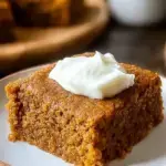 A stack of sliced Healthy Pumpkin Bars with dark chocolate chips on a wooden board