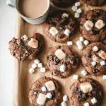 A close up of a fudgy Vegan Gluten-Free Hot Chocolate Cookie topped with melted white marshmallows and chocolate chips.