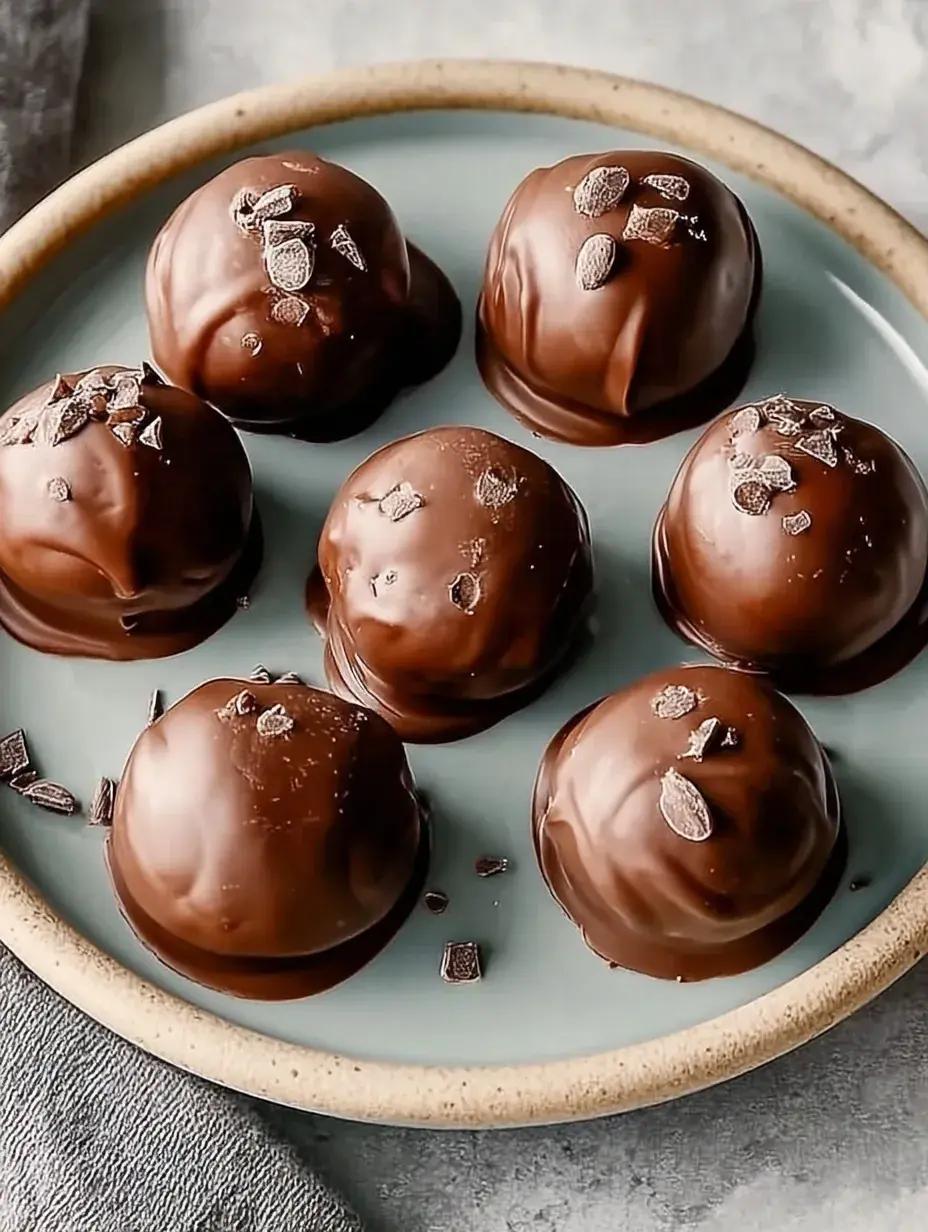 A platter of Juicy Chocolate Chip Cookie Dough Truffles with one bitten open to show the soft center