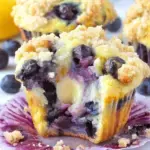 Freshly baked Lemon Blueberry Muffins on a wire cooling rack with golden tops