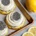 Freshly baked Lemon Poppy Seed Cheesecake Cookies on a wire rack showing the soft texture and poppy seeds