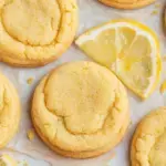 A stack of soft lemon sugar cookies coated in granulated sugar on a cooling rack