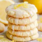 A plate of sparkling Lemon Sugar Cookies with golden edges and a sugar-dusted top