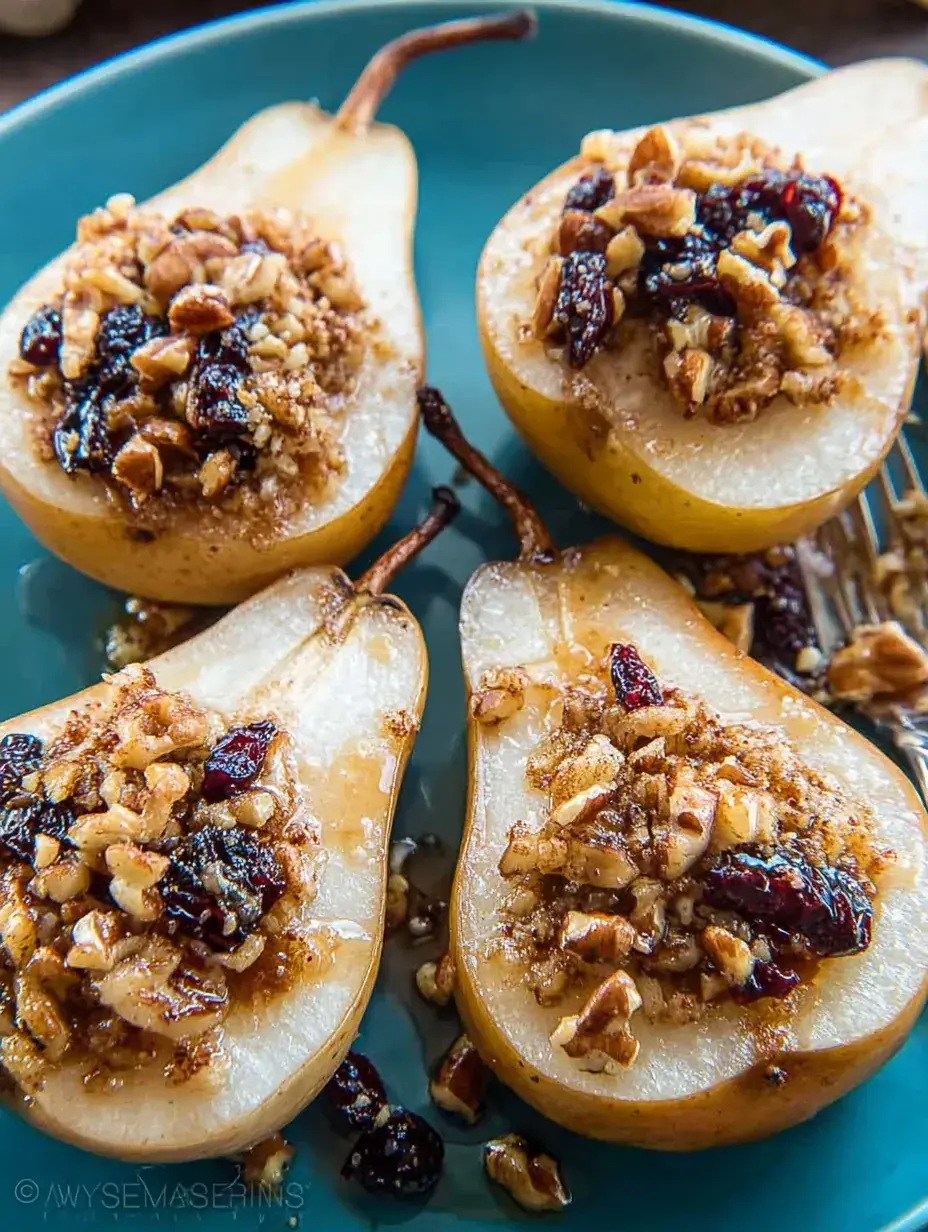 Warm Maple Pecan Baked Pears topped with toasted nuts and golden syrup in a baking dish.