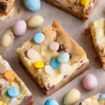 A close up of sliced Mini Egg Cheesecake Cookie Bars showing the layers