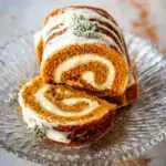 A sliced moist pumpkin roll with cassava and coconut flours showing a beautiful cream cheese swirl