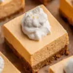 Chilled No-Bake Pumpkin Cheesecake Bars sliced into squares on a white plate