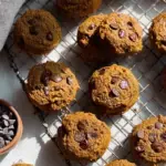 Freshly baked Paleo Pumpkin Chocolate Chip Cookies on a parchment-lined baking sheet