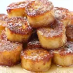 Golden brown pan fried cinnamon bananas caramelized in a skillet with honey