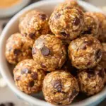 A plate of round Peanut Butter Oatmeal Balls showing textures of oats and chocolate chips