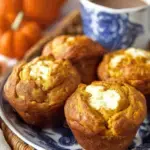 Freshly baked Pumpkin Cream Cheese Muffins on a wire cooling rack