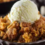 A warm dish of Pumpkin Crisp with a golden oat and pecan topping