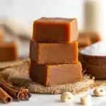 Squares of smooth orange Pumpkin Pie Fudge on a plate