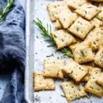 Homemade Sourdough Discard Crackers with flaky salt on a baking sheet