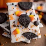 A close-up shot of Spooky Halloween Oreo Bark with white chocolate, crushed cookies, and candy eyes.