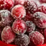 A bowl of sparkling Sugared Cranberries coated in white sugar crystals