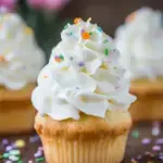 A close up of fluffy and smooth Swiss Meringue Buttercream in a mixing bowl