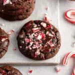 A tray of rich dark Vegan Chocolate Peppermint Cookies topped with crushed red and white candy canes
