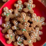 Classic Vegan Gingerbread Cookies cut into festive shapes on a baking sheet