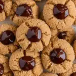 A tray of Vegan Peanut Butter Blossoms with soft cracked edges and chocolate centers
