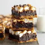 A close up of a fudgy Vegan S'mores Brownies square with toasted marshmallows and graham crackers on top.