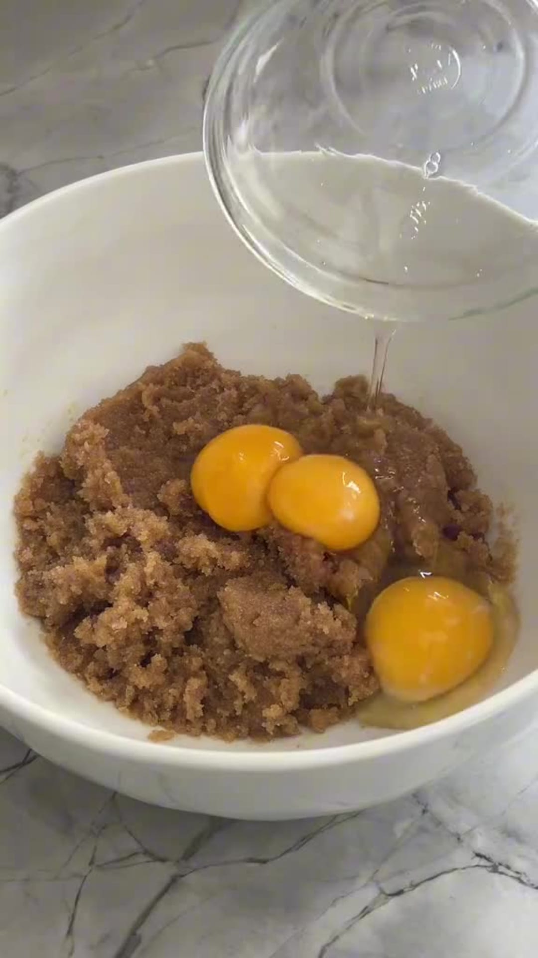 Chewy Brown Butter Chocolate Chunk Cookies - Mixing eggs into brown sugar and butter