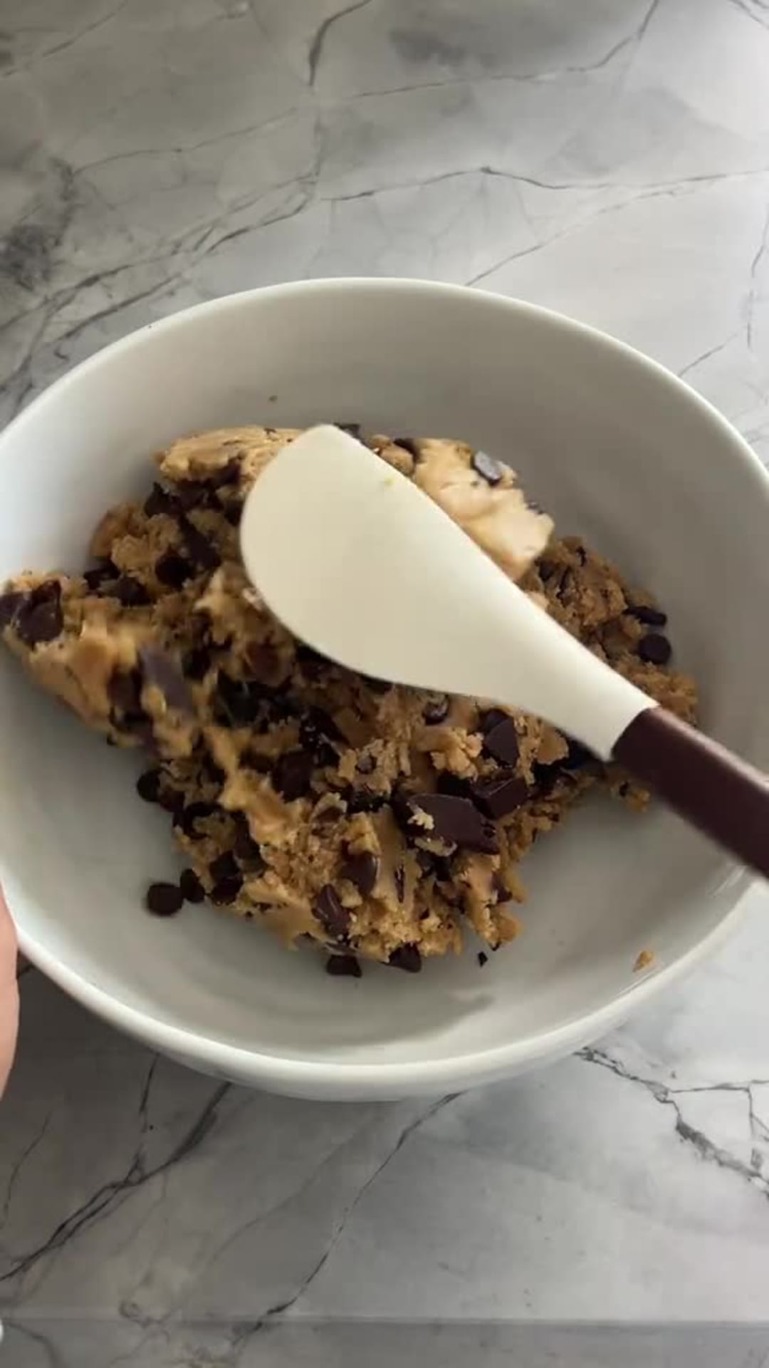 Chewy Brown Butter Chocolate Chunk Cookies - Folding chocolate chunks into cookie dough